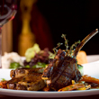 Lamb cutlets elegantly arranged on a plate in a restaurant